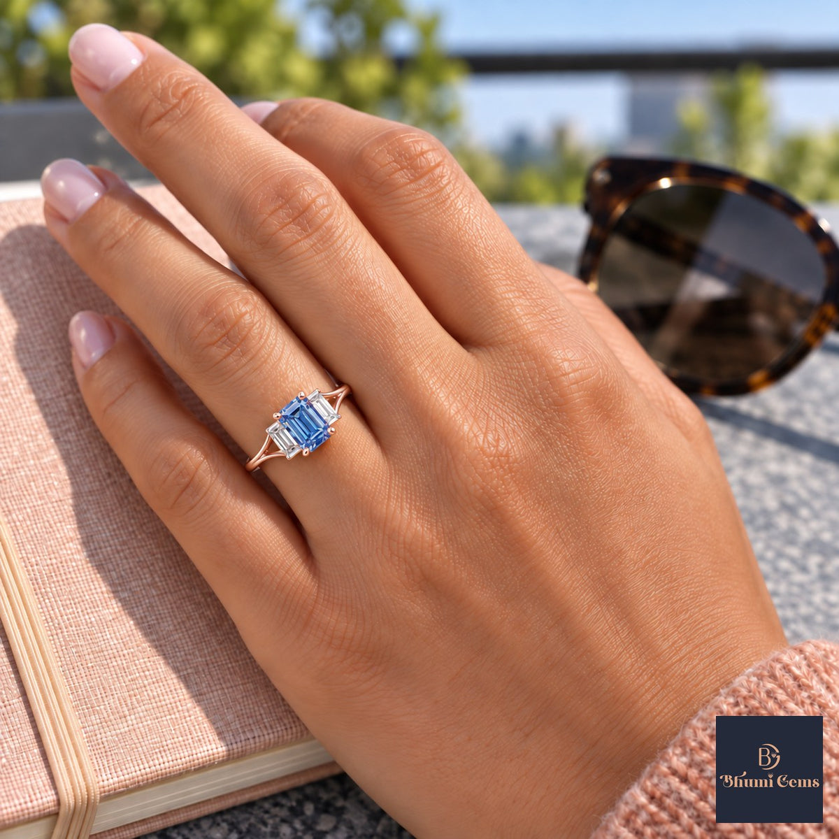Blue Emerald Cut Lab Grown Diamond Engagement Ring - Trapezoid Three Stone in rose gold, worn on the hand