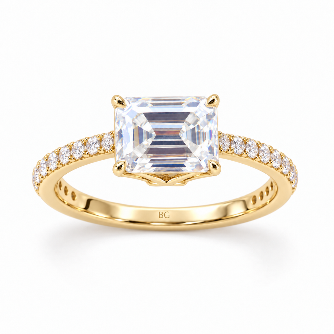 Emerald cut moissanite engagement ring set east-west in yellow gold