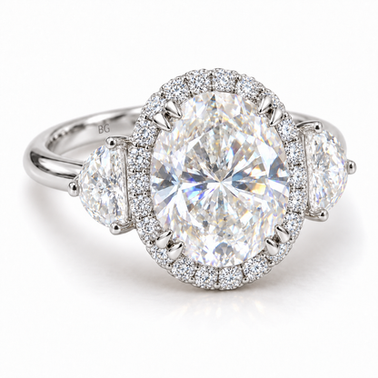 Oval moissanite halo engagement ring with half-moon side stones in white gold