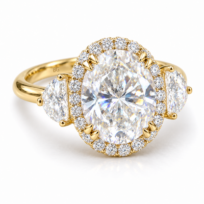 Oval moissanite halo engagement ring with half-moon side stones in yellow gold