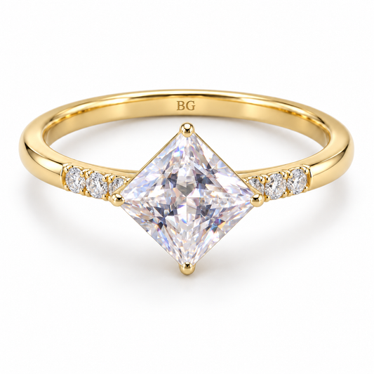 Princess cut moissanite kite set engagement ring with accented shoulders in yellow gold