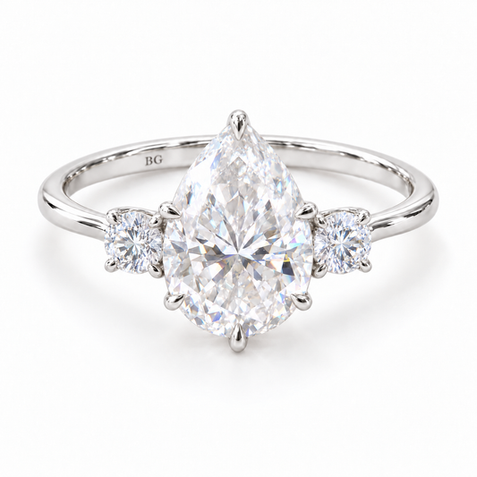 Pear moissanite three stone engagement ring with round side stones in white gold