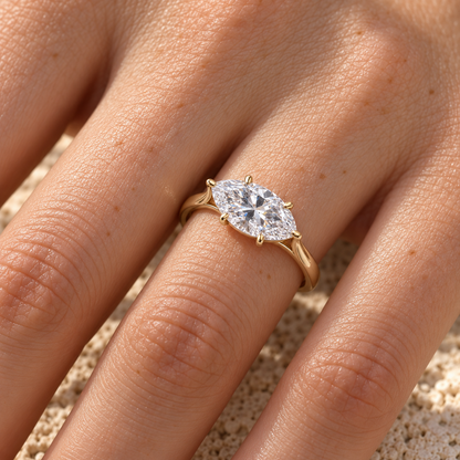 East-west marquise moissanite solitaire ring in yellow gold worn on the hand