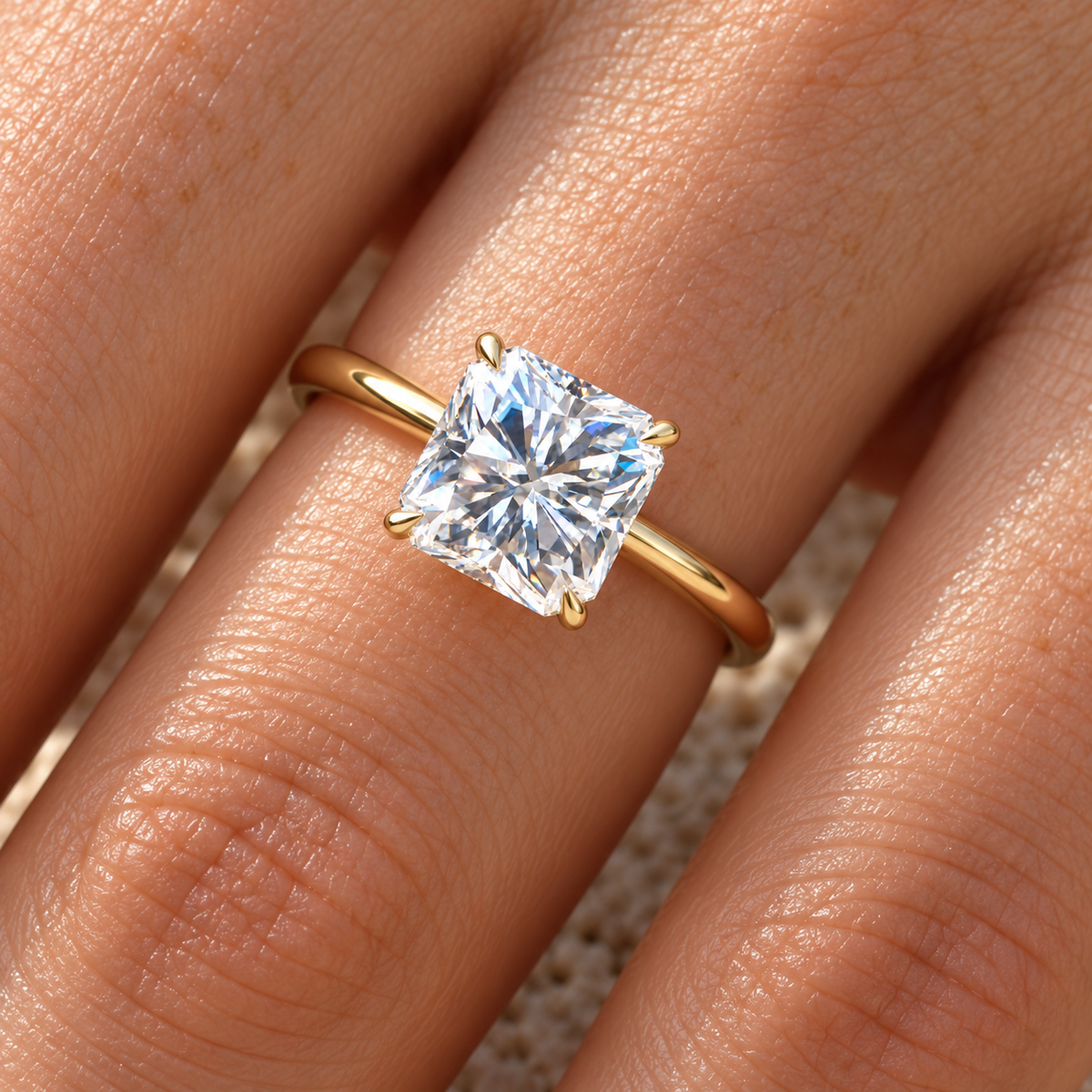 Square radiant moissanite solitaire ring in yellow gold worn on the hand