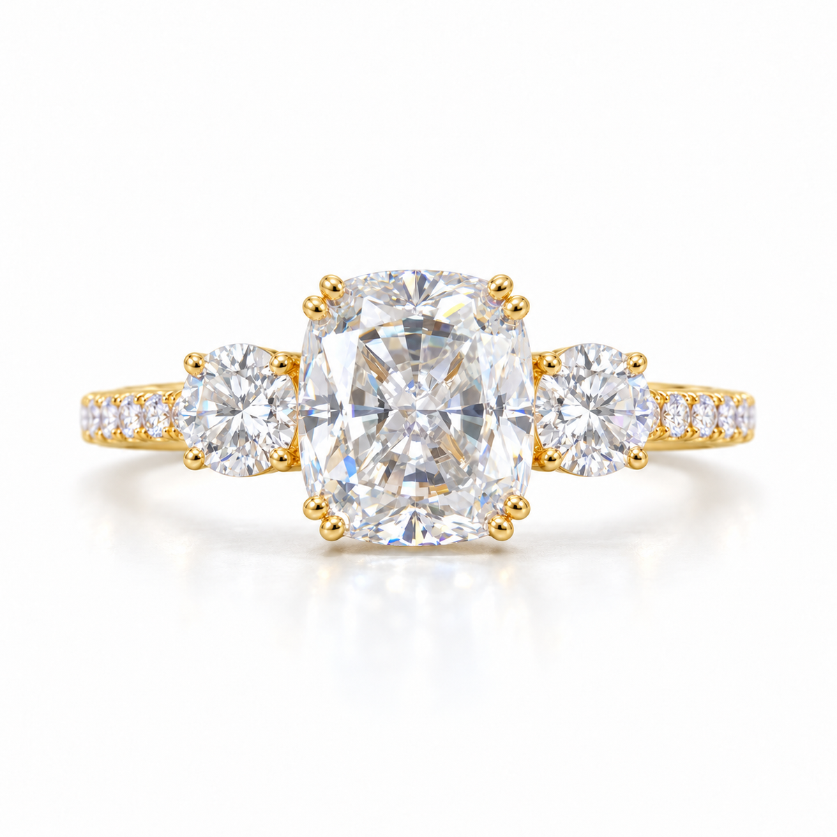 Elongated cushion moissanite three stone engagement ring in yellow gold