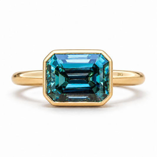 4 CT blue emerald cut moissanite east-west bezel engagement ring in yellow gold