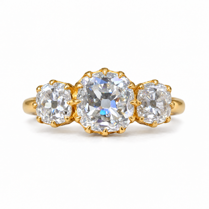5 TCW old mine cushion moissanite three stone engagement ring with claw prongs in yellow gold