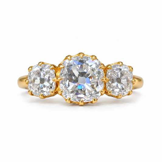 5 TCW old mine cushion moissanite three stone engagement ring with claw prongs in yellow gold