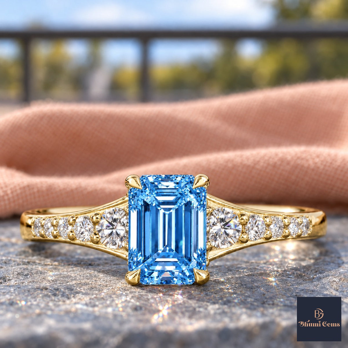 Blue Emerald Cut Lab Grown Diamond Engagement Ring - Graduated Pave Shoulders in yellow gold, close-up
