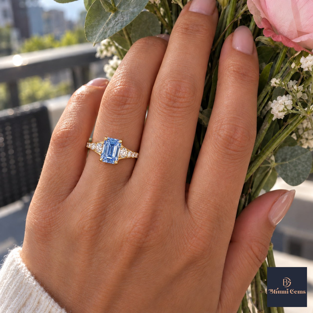 Blue Emerald Cut Lab Grown Diamond Engagement Ring - Graduated Pave Shoulders in yellow gold, worn on the hand