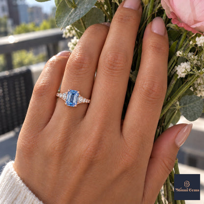 Blue Emerald Cut Lab Grown Diamond Engagement Ring - Graduated Pave Shoulders in rose gold, worn on the hand