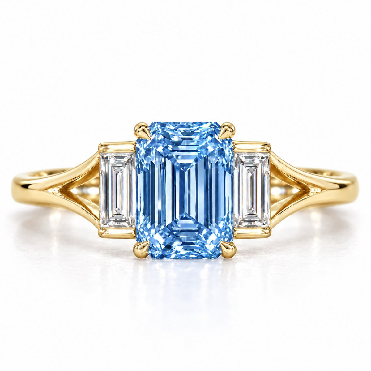 Blue Emerald Cut Lab Grown Diamond Engagement Ring - Trapezoid Three Stone in yellow gold, front view