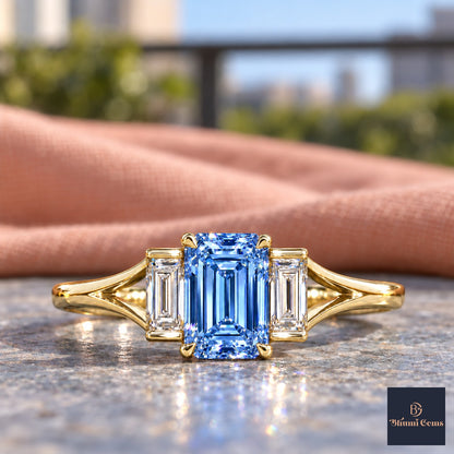 Blue Emerald Cut Lab Grown Diamond Engagement Ring - Trapezoid Three Stone in yellow gold, close-up