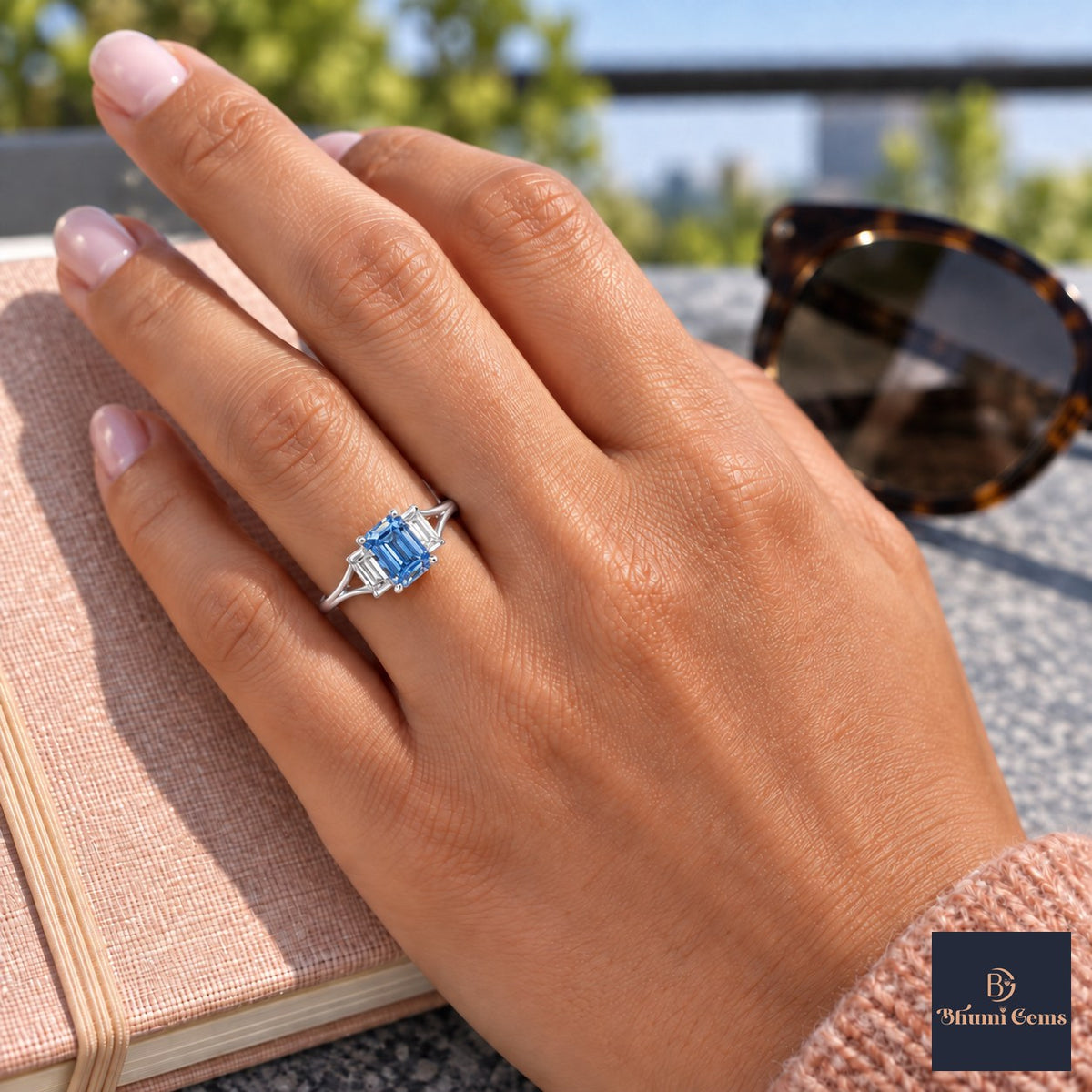 Blue Emerald Cut Lab Grown Diamond Engagement Ring - Trapezoid Three Stone in white gold, worn on the hand