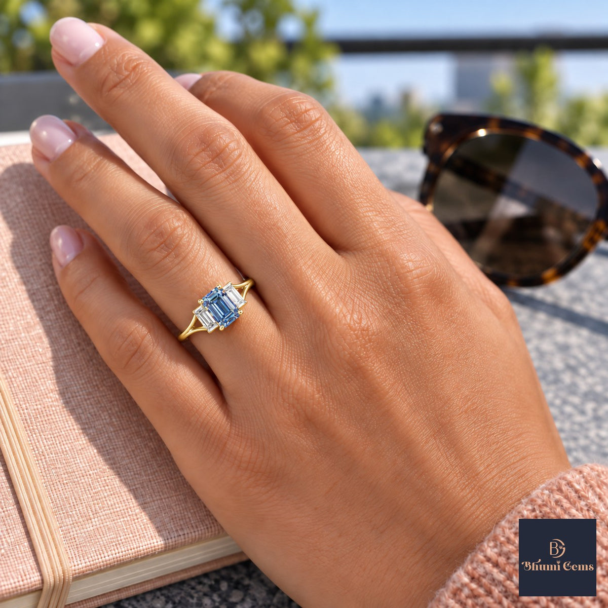 Blue Emerald Cut Lab Grown Diamond Engagement Ring - Trapezoid Three Stone in yellow gold, worn on the hand