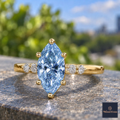 Blue Marquise Cut Lab Grown Diamond Engagement Ring - Round Accents in yellow gold, close-up