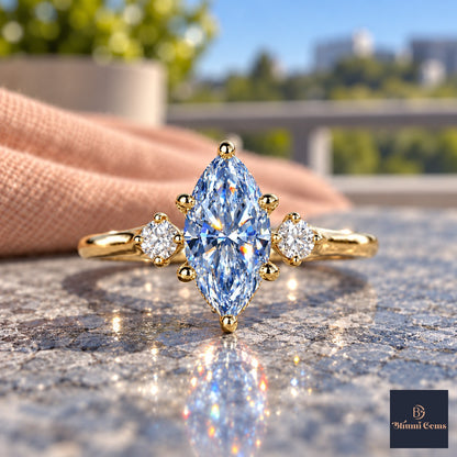 Blue Marquise Cut Lab Grown Diamond Engagement Ring - Three Stone in yellow gold, close-up