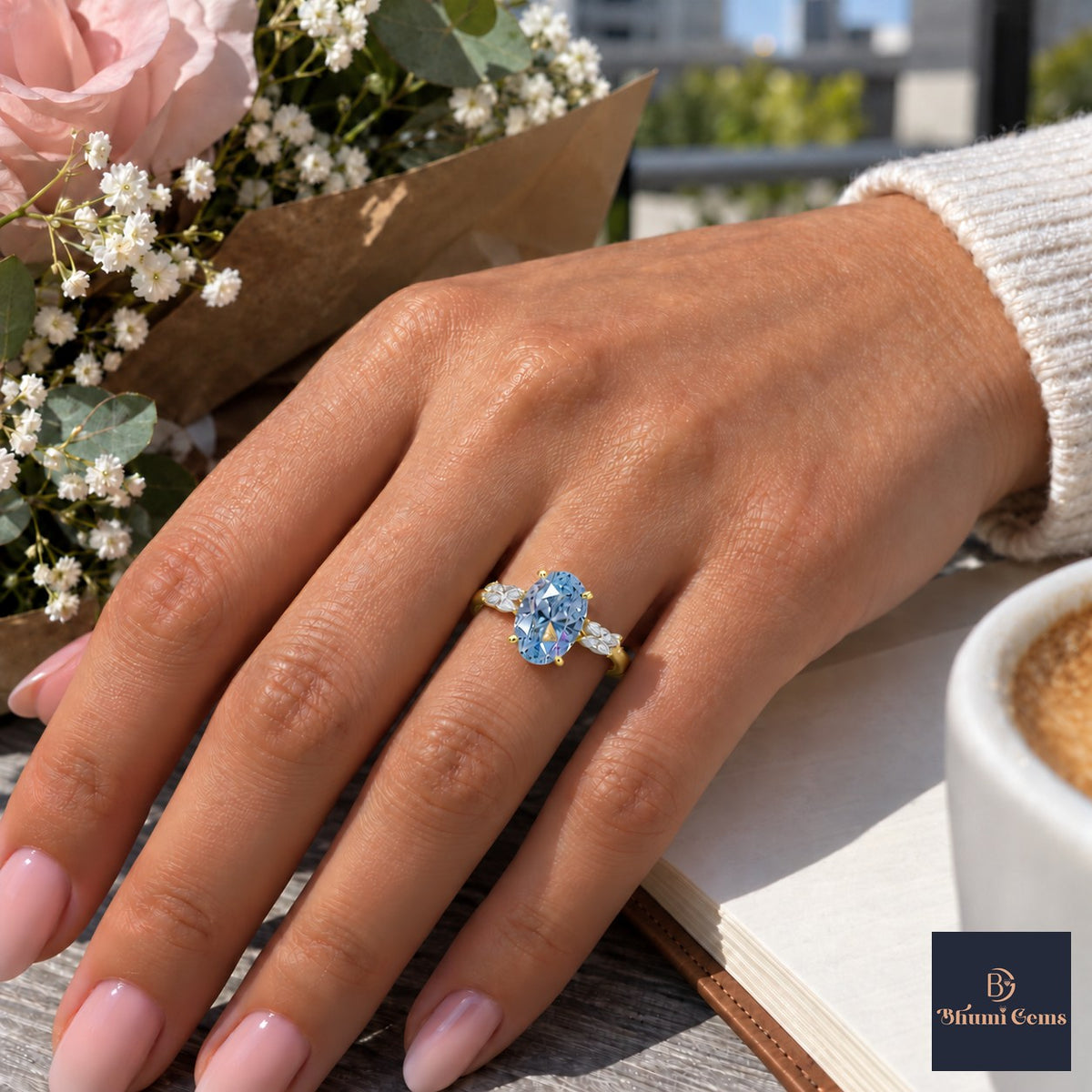 Blue Oval Cut Lab Grown Diamond Engagement Ring - Leaf Bypass in yellow gold, worn on the hand