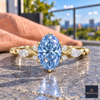 Blue Oval Cut Lab Grown Diamond Engagement Ring - Leaf Cluster Shoulders in yellow gold, close-up