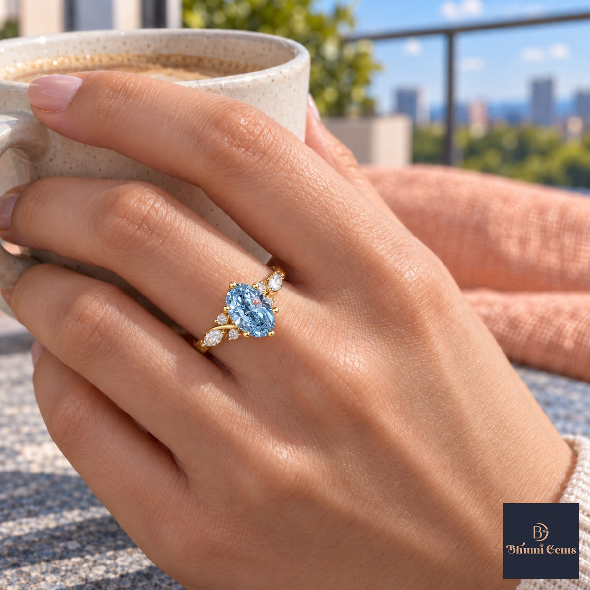 Blue Oval Cut Lab Grown Diamond Engagement Ring - Leaf Cluster Shoulders in yellow gold, on the hand