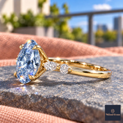 Blue Oval Cut Lab Grown Diamond Engagement Ring - Marquise and Round Accents in yellow gold, side view