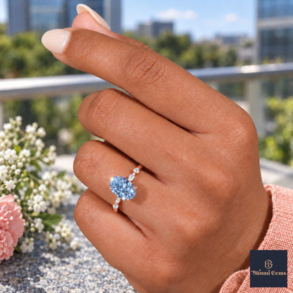 Blue Oval Cut Lab Grown Diamond Engagement Ring - Marquise and Round Accents in rose gold, worn on the hand