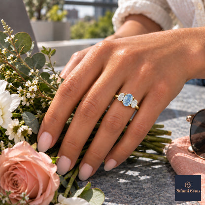 Blue Oval Cut Lab Grown Diamond Engagement Ring - Oval Three Stone in yellow gold, worn on the hand