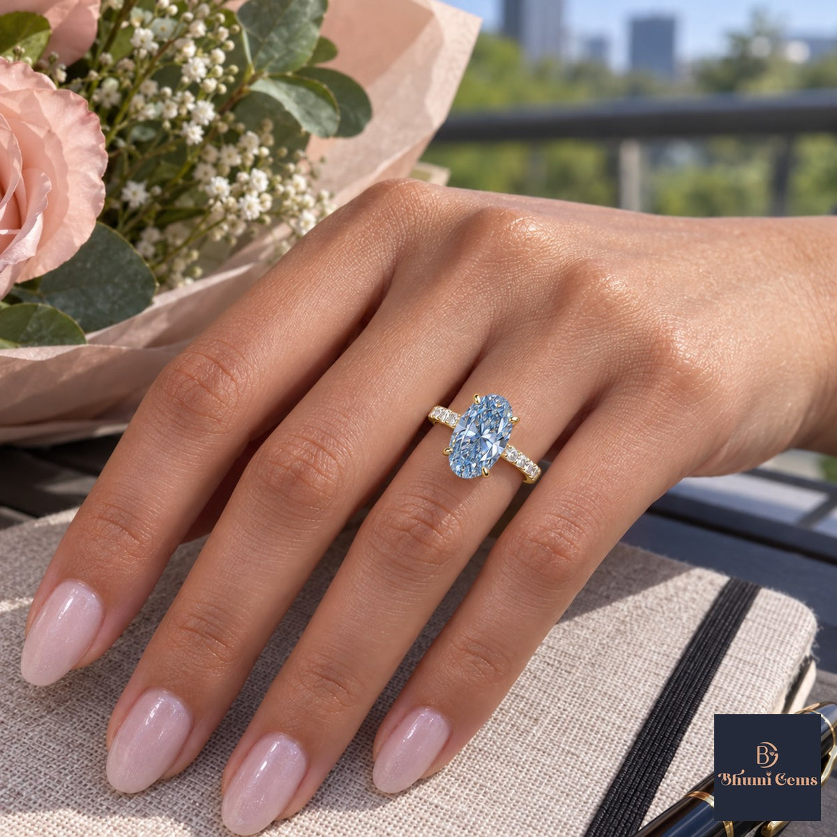Blue Oval Cut Lab Grown Diamond Engagement Ring - Pave Band in yellow gold, worn on the hand