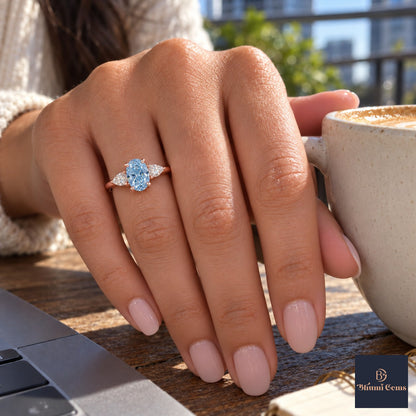 Blue Oval Cut Lab Grown Diamond Engagement Ring - Pear Side Stones in rose gold, on the hand