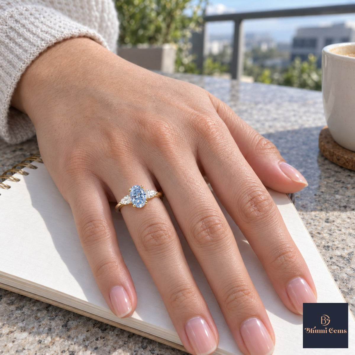 Blue Oval Cut Lab Grown Diamond Engagement Ring - Pear Side Stones in yellow gold, worn on the hand
