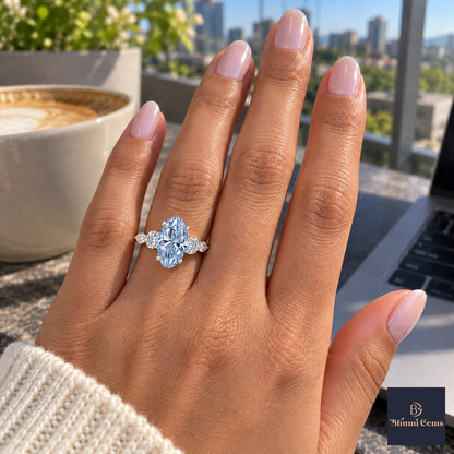 Blue Oval Cut Lab Grown Diamond Engagement Ring - Round and Marquise Accents in white gold, on the hand