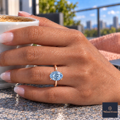 Blue Oval Cut Lab Grown Diamond Engagement Ring - Six Prong Solitaire in rose gold, on the hand