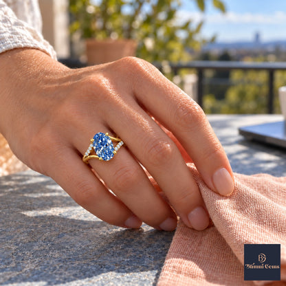 Blue Oval Cut Lab Grown Diamond Engagement Ring - Split Pave Shoulders in yellow gold, worn on the hand