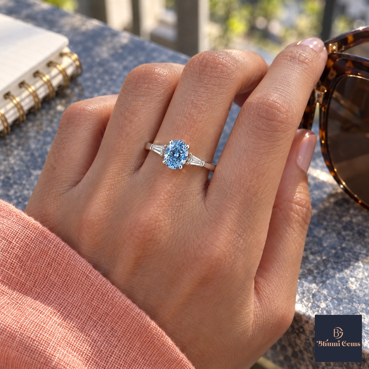 Blue Oval Cut Lab Grown Diamond Engagement Ring - Tapered Baguettes in white gold, worn on the hand