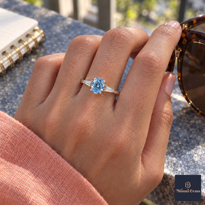 Blue Oval Cut Lab Grown Diamond Engagement Ring - Tapered Baguettes in white gold, worn on the hand