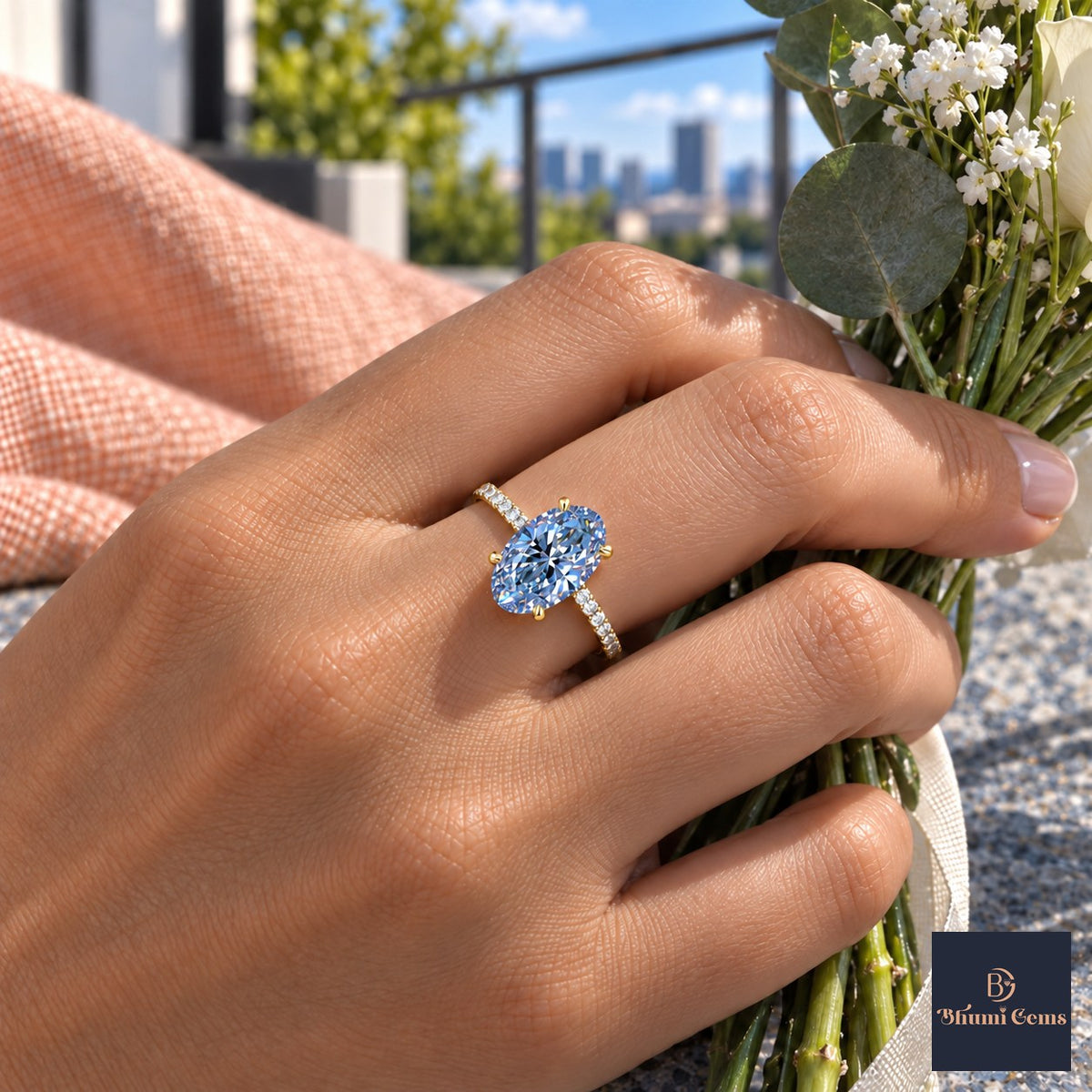 Blue Oval Cut Lab Grown Diamond Engagement Ring - Thin Pave Band in yellow gold, worn on the hand