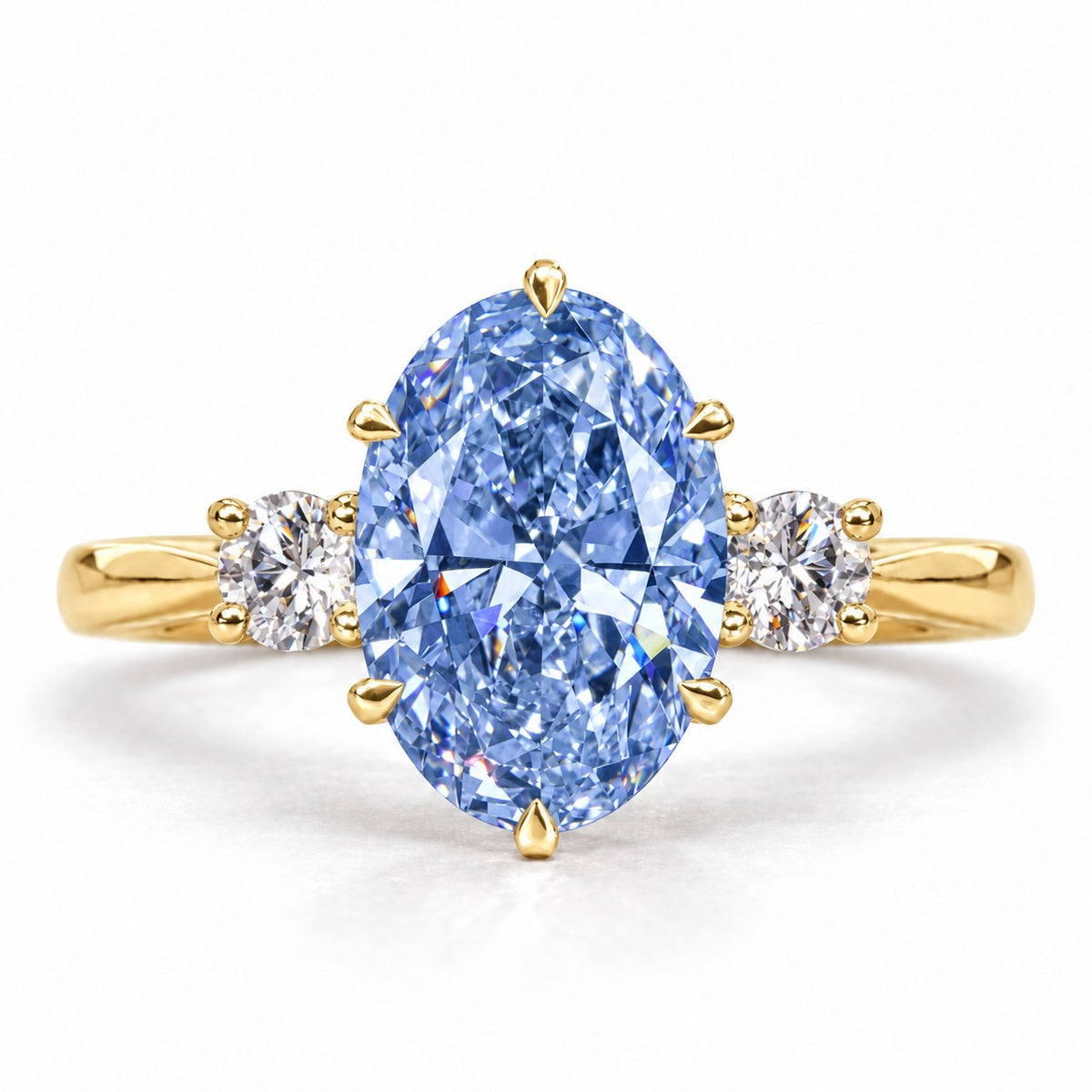 Blue Oval Cut Lab Grown Diamond Engagement Ring - Three Stone in yellow gold, front view