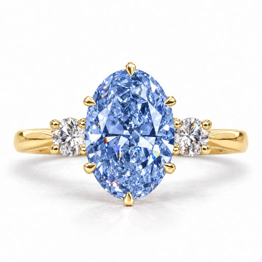 Blue Oval Cut Lab Grown Diamond Engagement Ring - Three Stone in yellow gold, front view