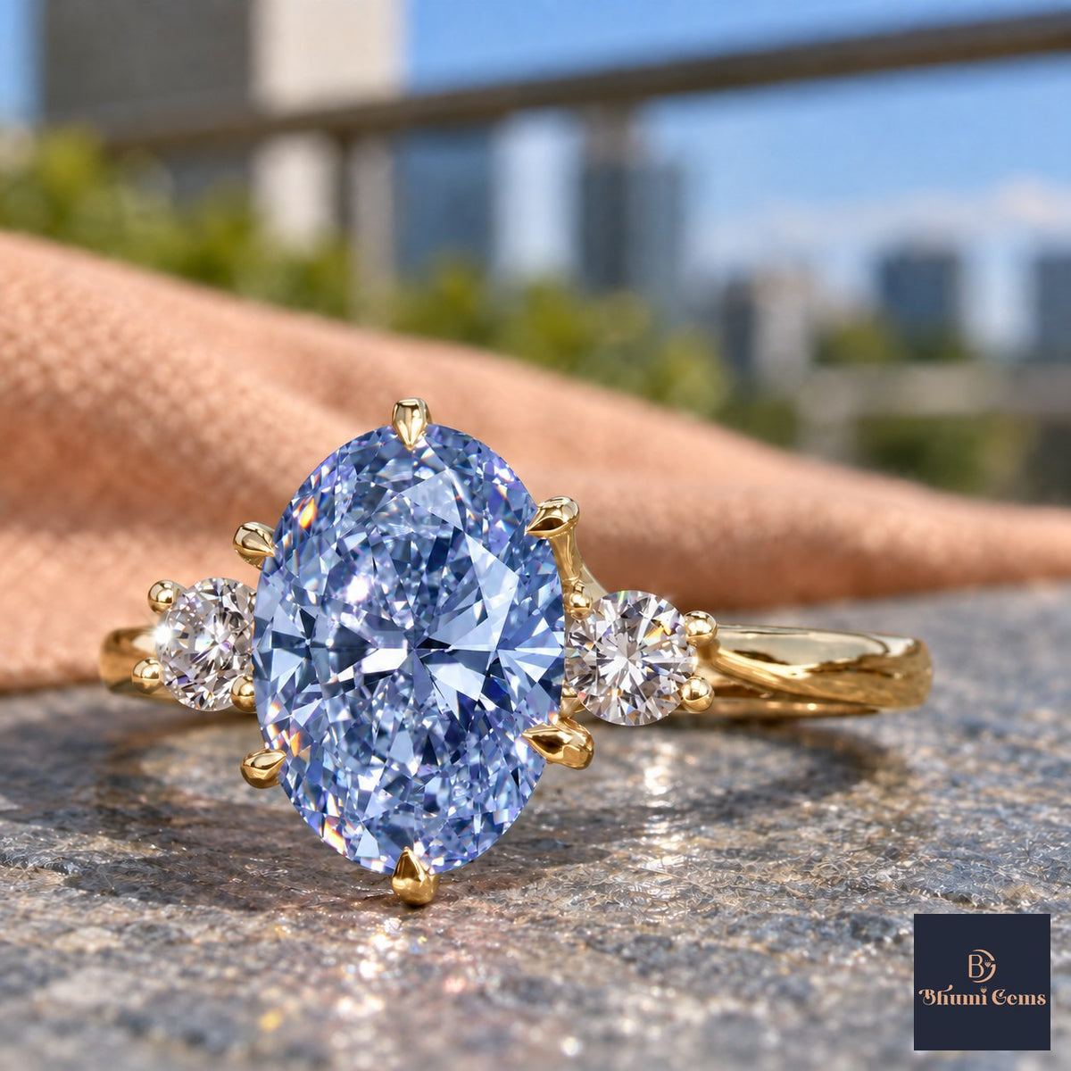 Blue Oval Cut Lab Grown Diamond Engagement Ring - Three Stone in yellow gold, close-up