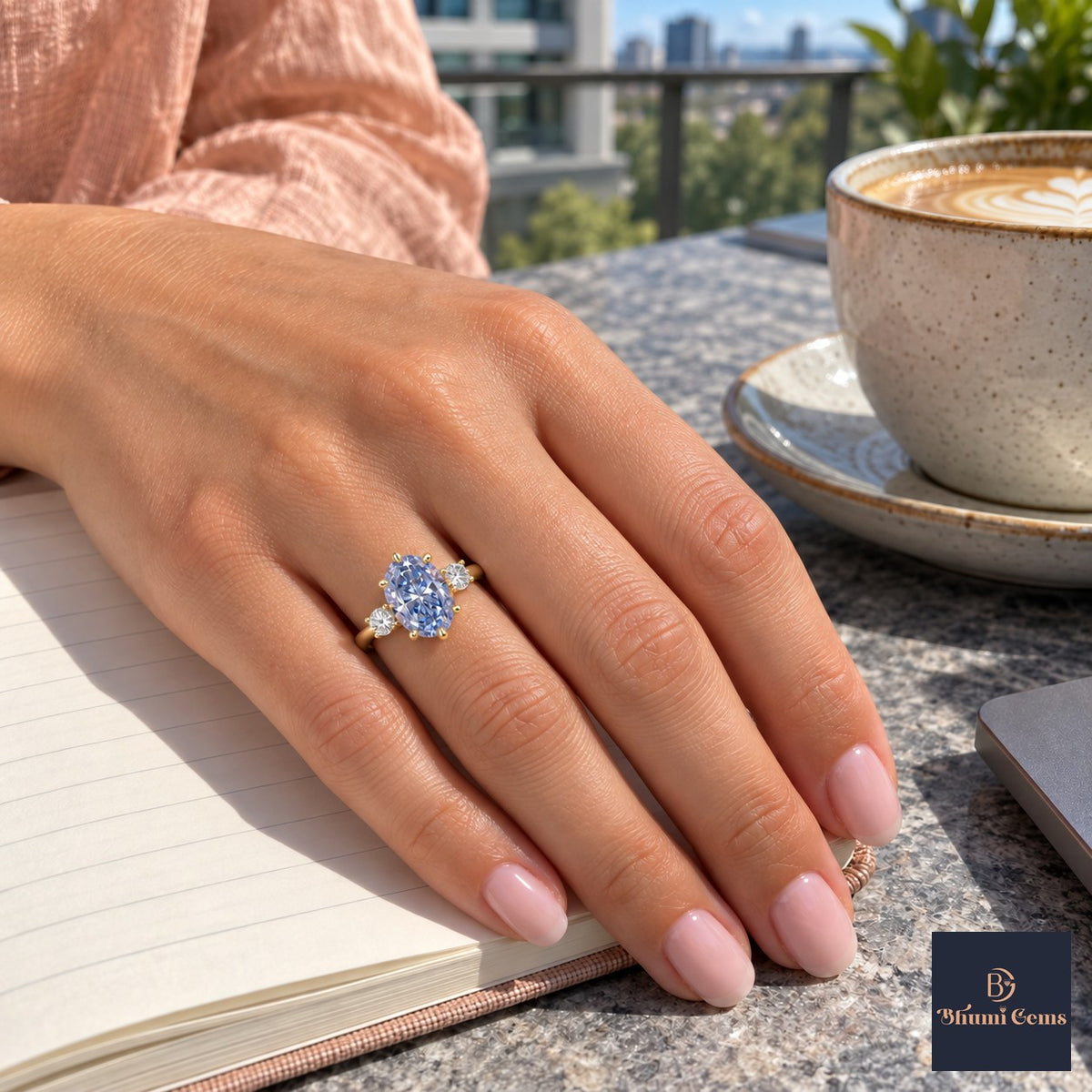 Blue Oval Cut Lab Grown Diamond Engagement Ring - Three Stone in yellow gold, worn on the hand
