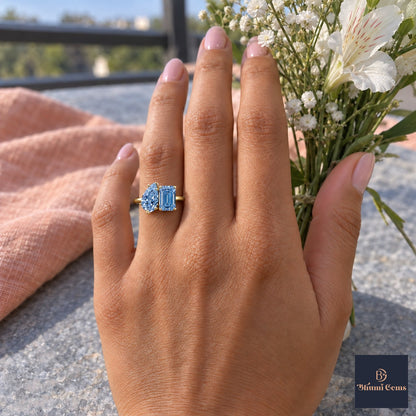 Blue Pear and Emerald Cut Lab Grown Diamond Engagement Ring - Toi et Moi in yellow gold, worn on the hand