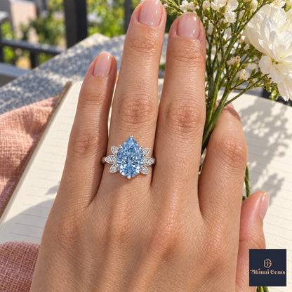 Blue Pear Cut Lab Grown Diamond Engagement Ring - Floral Leaf Accents in white gold, worn on the hand