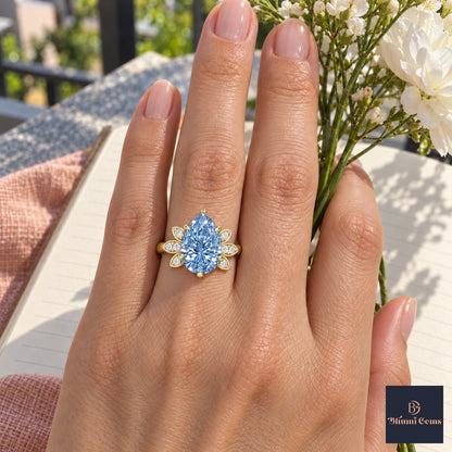 Blue Pear Cut Lab Grown Diamond Engagement Ring - Floral Leaf Accents in yellow gold, worn on the hand