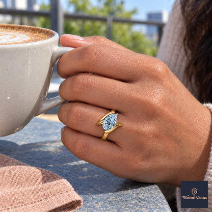 Blue Pear Cut Lab Grown Diamond Engagement Ring - Wrap Bypass Solitaire in yellow gold, on the hand