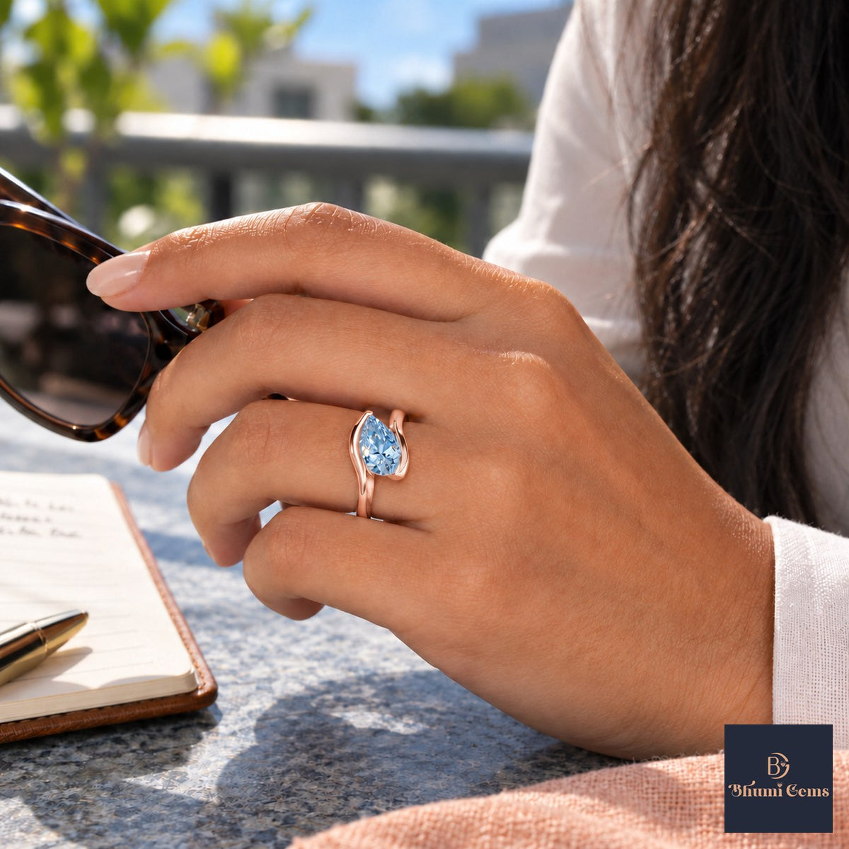 Blue Pear Cut Lab Grown Diamond Engagement Ring - Wrap Bypass Solitaire in rose gold, worn on the hand