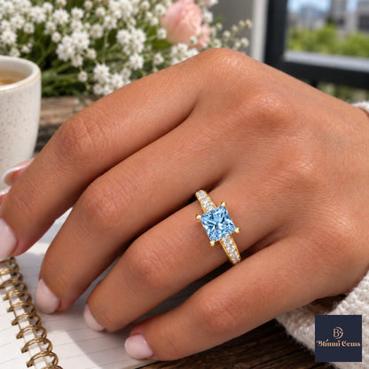 Blue Princess Cut Lab Grown Diamond Engagement Ring - Pave Band in yellow gold, worn on the hand
