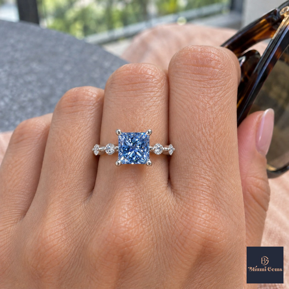 Blue Princess Cut Lab Grown Diamond Engagement Ring - Station Band in white gold, on the hand