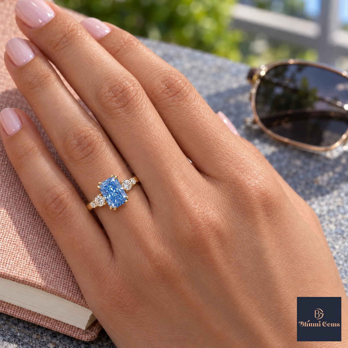 Blue Radiant Cut Lab Grown Diamond Engagement Ring - Round Accents in yellow gold, worn on the hand