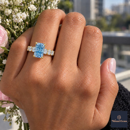 Blue Radiant Cut Lab Grown Diamond Engagement Ring - Shared Prong Band in yellow gold, worn on the hand