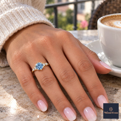 Blue Round Cut Lab Grown Diamond Engagement Ring - Cluster Shoulders in yellow gold, on the hand